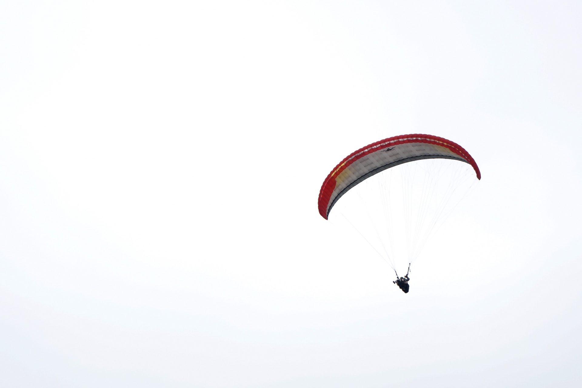 Parachutes descending onto a sports field 